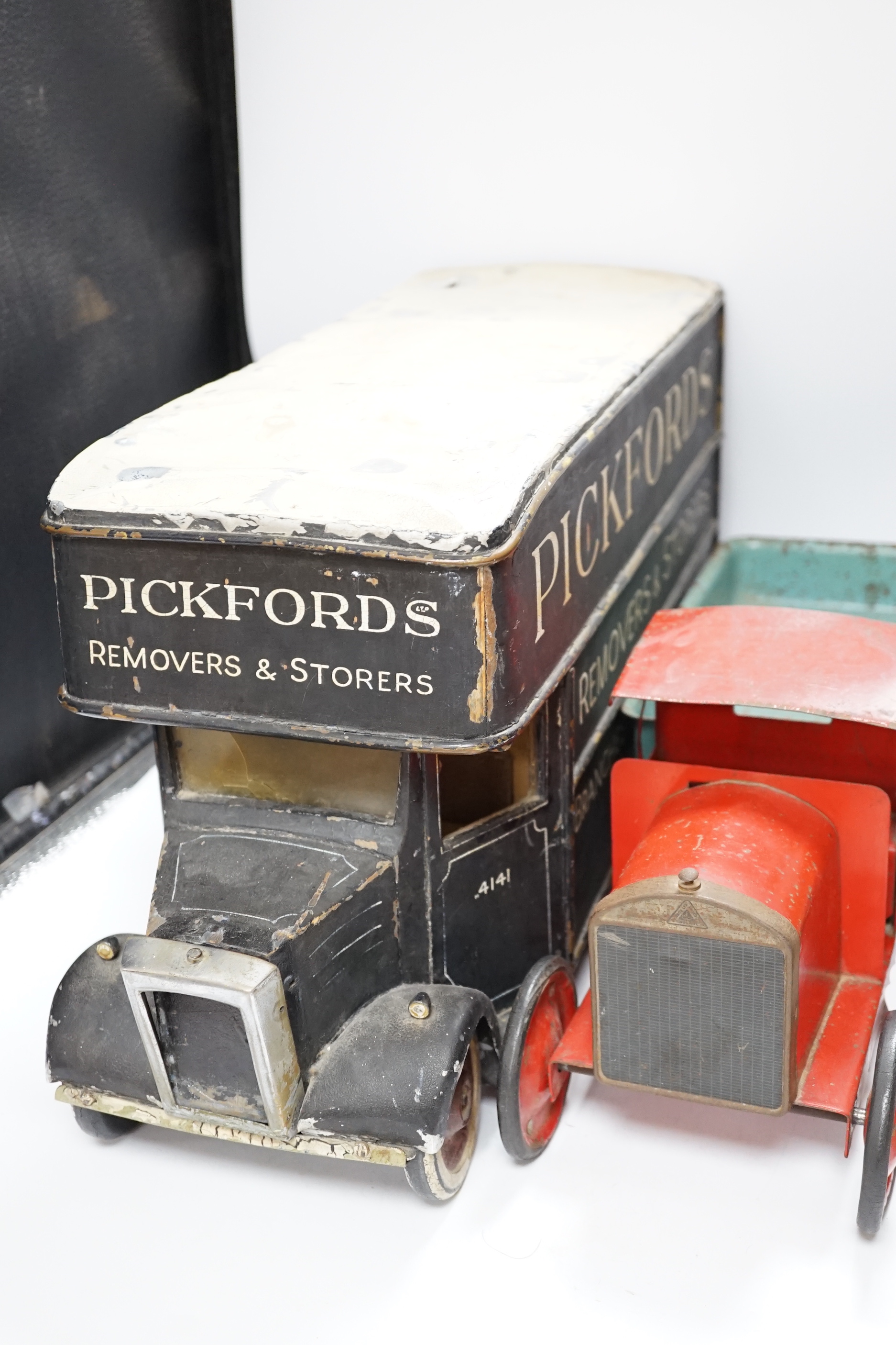 Three model vehicles including; a tinplate Tri-ang tipper lorry, a Pickfords removal van (believed to have been used as a shop window display) and a wooden bus, length of Pickfords van 54cm